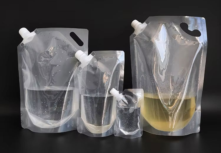 Liquid filled spout pouches